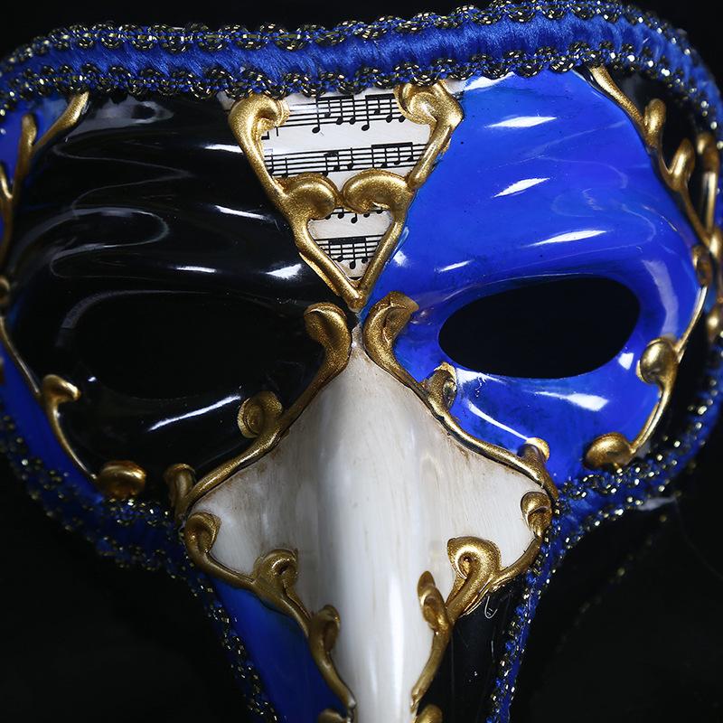 Masque vénitien long nez bicolore bleu et noir avec décor doré et partition musicale au centre